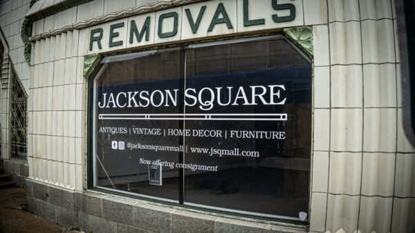 Storefront window of Jackson Square antiques and home décor store with a vintage "Removals" sign above the entrance.